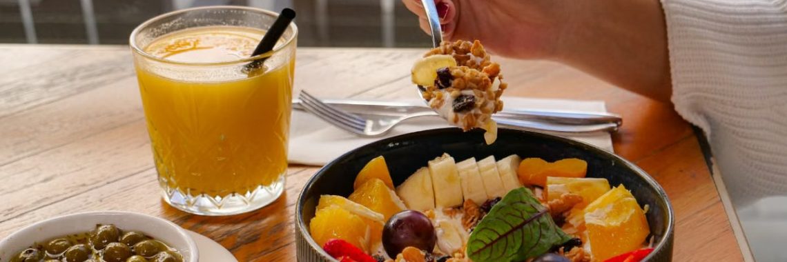 Enjoy a nutritious breakfast with fruit, nuts, and juice in a calm setting in İzmir, Türkiye.
